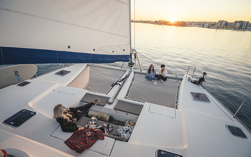 sail superior, sail boat, water, three women, sunset