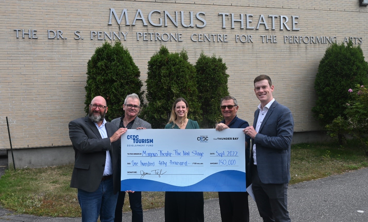 TDF cheque photo with staff of magnus theatre