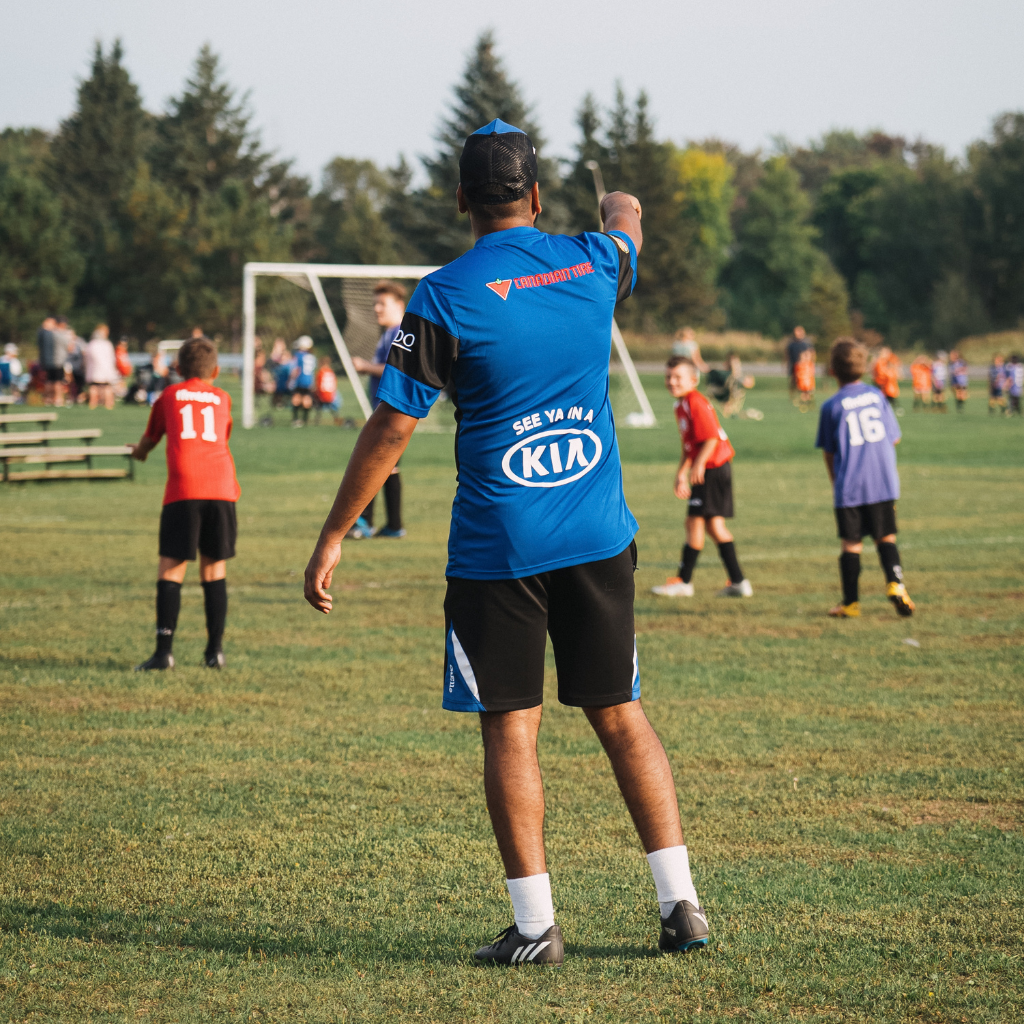 Coach with players on soccer field