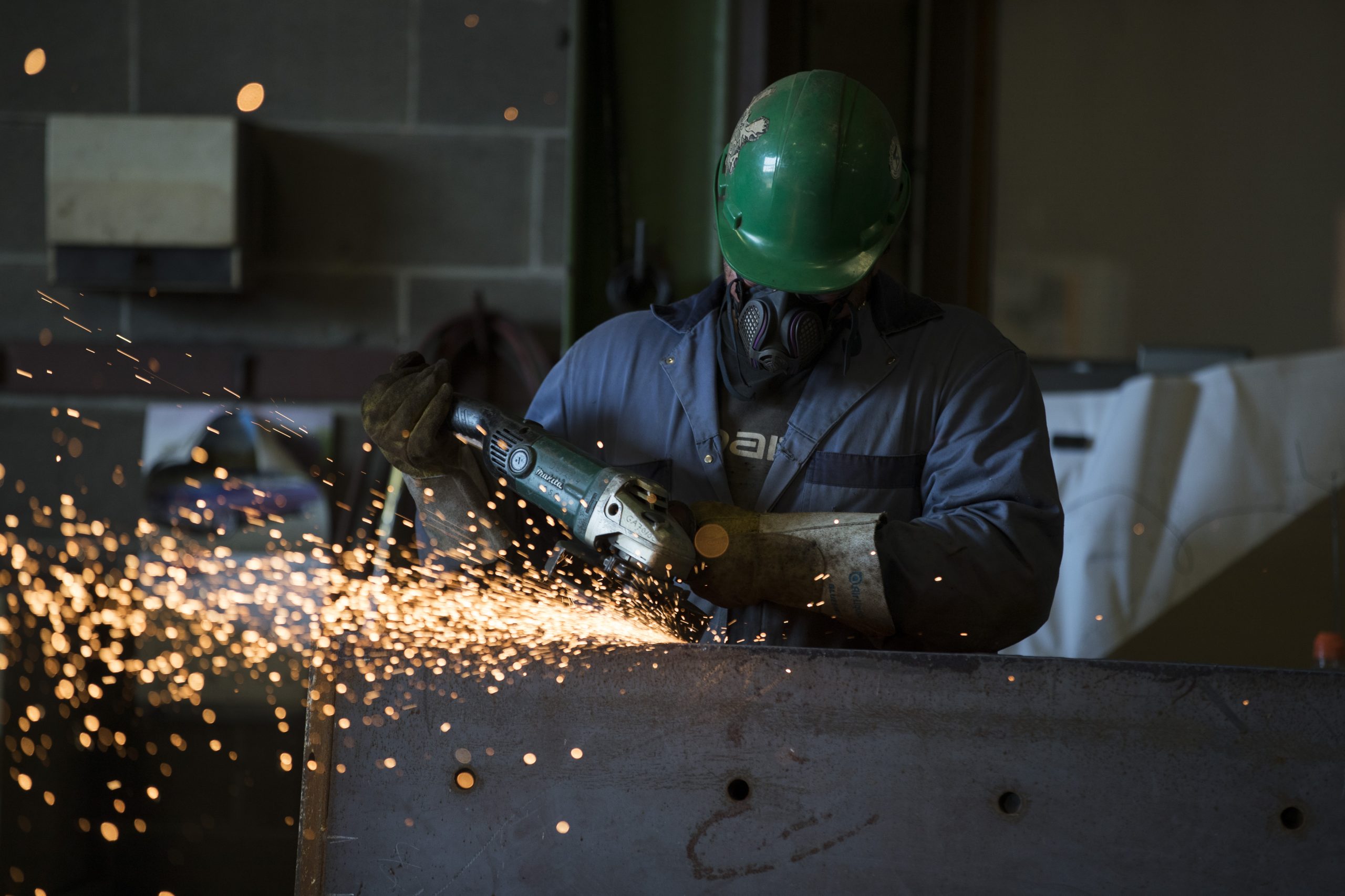 tradesmen grinding steel on job site
