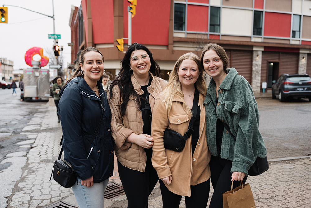 4 females standing together on a street